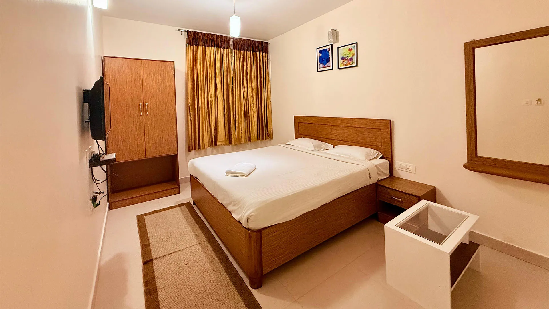 Aerial view of hillside cottages amidst lush greenery at the best stays in Ooty.