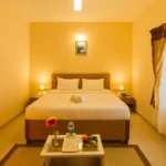 Sunset view from a nature cottage balcony at the best stays in Ooty.