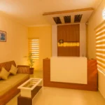 Morning mist surrounding cozy hillside cottages at the best stays in Ooty.