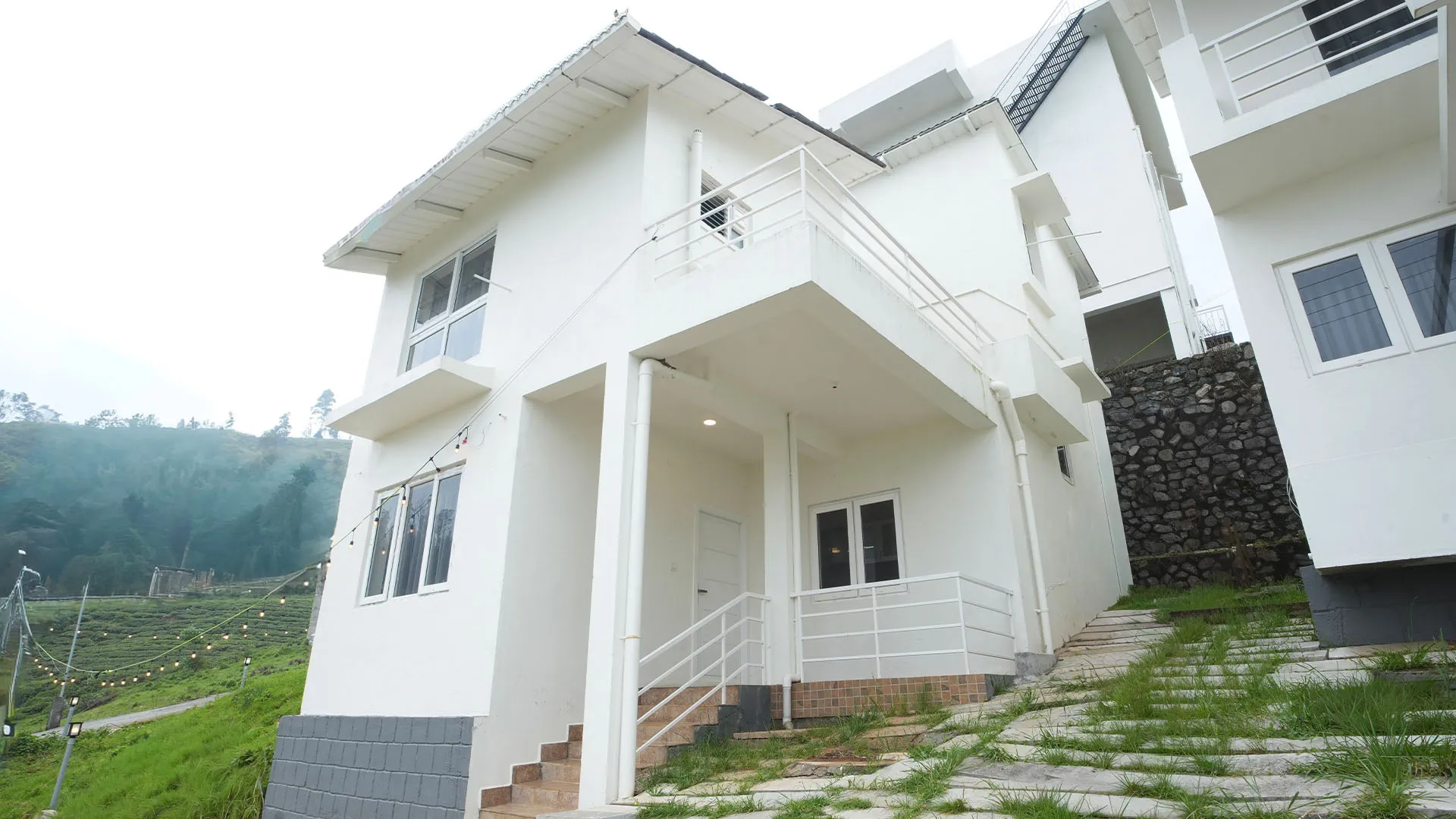 Guests enjoying tea overlooking mountains at the best stays in Ooty.