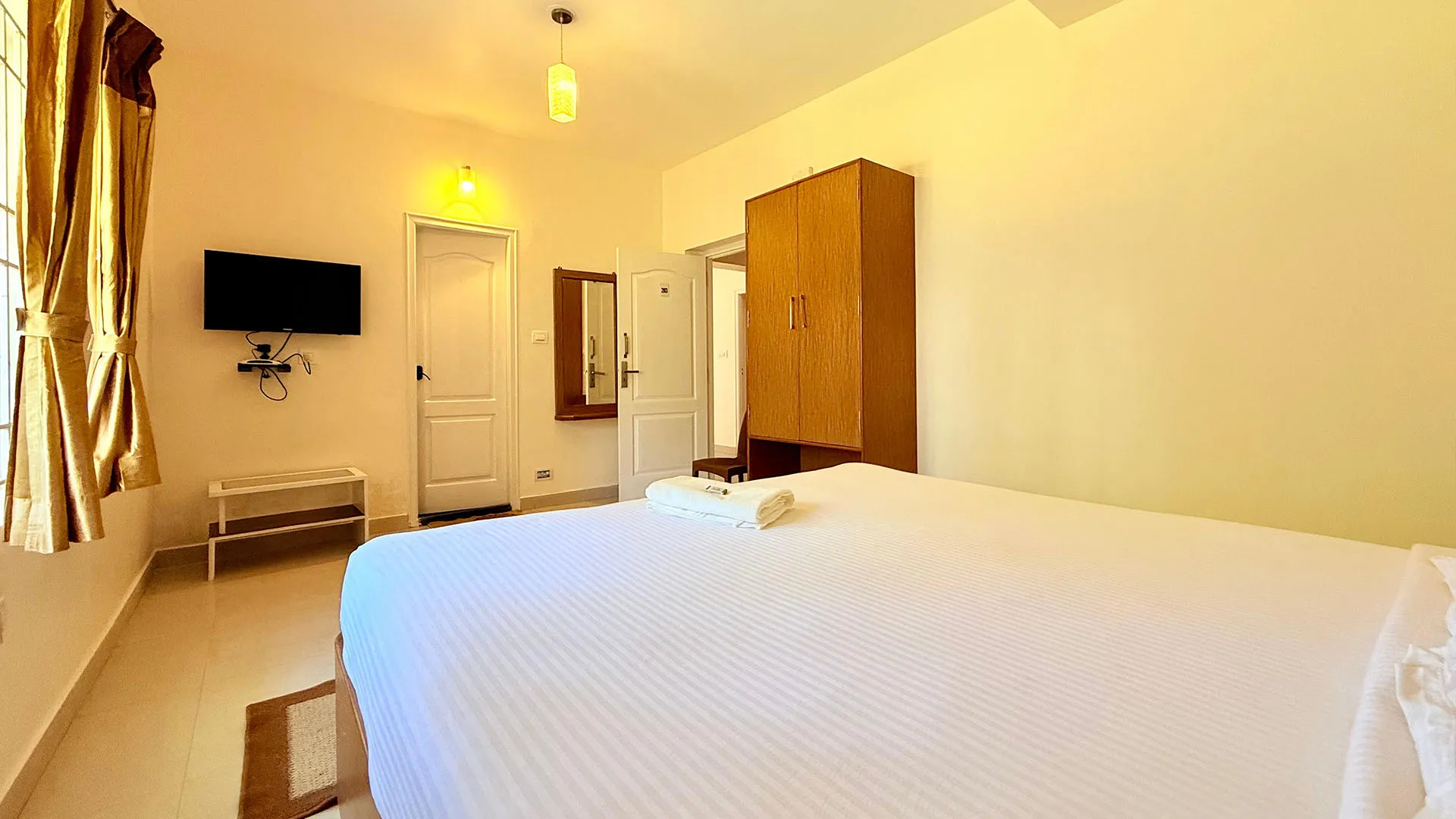 Couple sitting near a bonfire outside a cottage at the best stays in Ooty.